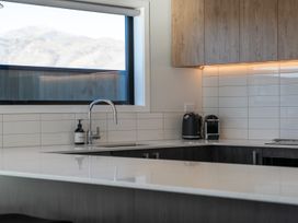 A kitchen with a sink, kettle, and coffee machine at Harper on Hadley - Cromwell Holiday Home, Cromwell