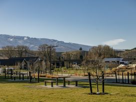 An outdoor area with trees and picnic tables near mountains at Harper on Hadley - Cromwell