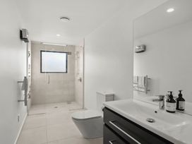 A bathroom with a shower and sink at Harper on Hadley - Cromwell Holiday Home Cromwell