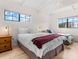 A bedroom with a bed and bedside table at Waipu