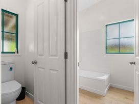 A bathroom with a toilet and a bath tub at Waipu