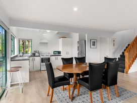 A kitchen with dining area and appliances at Waipu