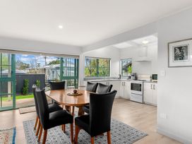 A dining room with a table and chairs at Waipu in Waipu