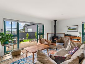 A living room with a wood stove and coffee table at Waipu, Waipu