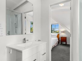 A bathroom with a sink and a mirror at Waipu