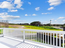 A view from a balcony showing a road and greenery at Waipu in Waipu