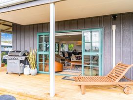 An outdoor area with a barbecue and seating at Waipu in Waipu