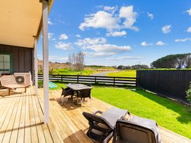 An outdoor area with a table and chairs at Waipu in Waipu