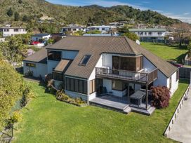 A house with a balcony and patio at Picton Holiday Home