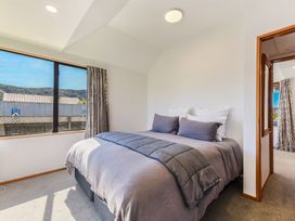 A bedroom with a bed and window at Picton Holiday Home