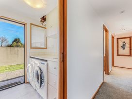 A laundry room with a washing machine and dryer at Picton Holiday Home
