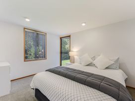 A bedroom with a bed and window at Picton Holiday Home