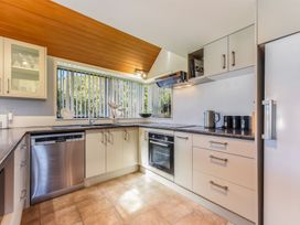 A kitchen with appliances including a stove and dishwasher at Picton Holiday Home