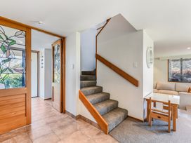 An entryway with a staircase and a table at Picton Holiday Home