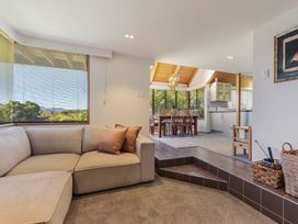 A living room with a sofa and dining area at Picton Holiday Home in 