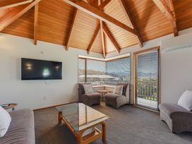 A living room with a television and seating area at Picton Holiday Home