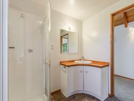 A bathroom with a shower and sink at Picton Holiday Home