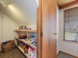 A storage room with shelves and baskets at Picton Holiday Home