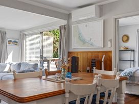 A dining room featuring a table and chairs at White-Sands Hideaway - Waihi Beach