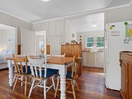 A dining room with a table and chairs at White-Sands Hideaway - Waihi Beach