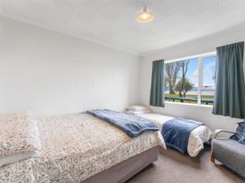A bedroom with two beds and a window at the property location