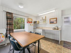 A kitchen with a table and chairs at The Old Barn in Manchester