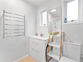A bathroom with a sink, towel rack, and toilet at the property