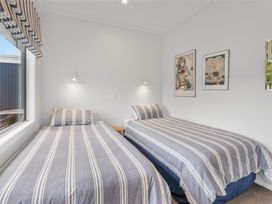 A bedroom with two beds and wall art at The Old Barn in Manchester