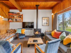 A living room with a fireplace and seating area at the property