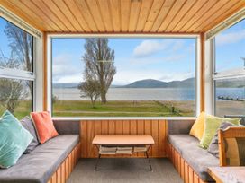 A sunroom with a view of a lake and mountains at the property