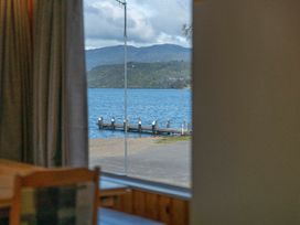 A view of a dock and water through a window at the property