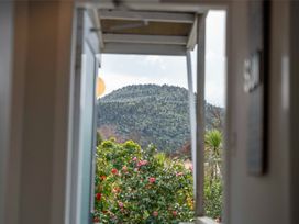 A view of a mountain and plants from a doorway at the property