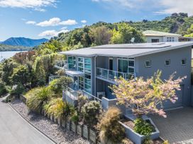 A modern house with a balcony and garden at Waikawa Holiday Home