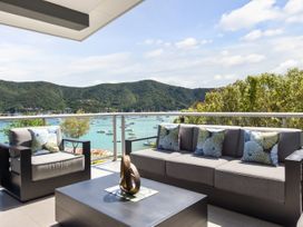 An outdoor seating area with a sofa and coffee table at Waikawa Holiday Home