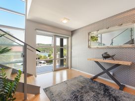 A hallway with a staircase and a table at Waikawa Holiday Home