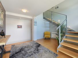 An entryway with a staircase and seating area at Waikawa Holiday Home