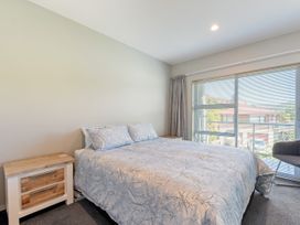 A bedroom with a bed and window at Waikawa Holiday Home