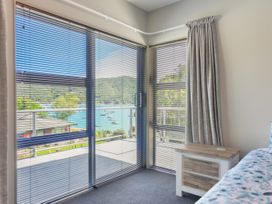 A bedroom with a view of the sea at Waikawa Holiday Home