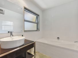 A bathroom with a sink and bathtub at Waikawa Holiday Home