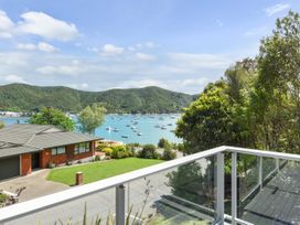 A view of a house and water with boats in Waikawa Holiday Home