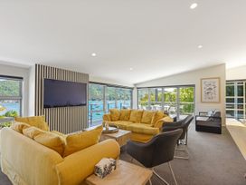 A living room with a sofa and television at Waikawa Holiday Home in 