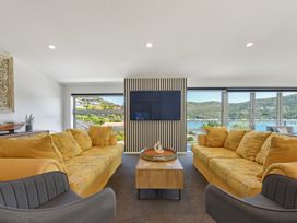 A living room with a television and sofa at Waikawa Holiday Home