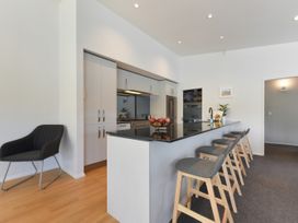 A kitchen with a counter and stools at Waikawa Holiday Home