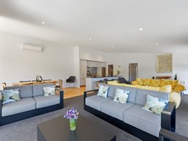 A living room with a sofa and dining table at Waikawa Holiday Home