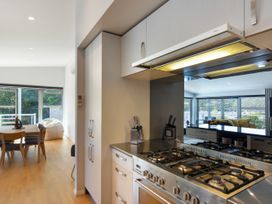 A kitchen with a gas stove and dining table at Waikawa Holiday Home