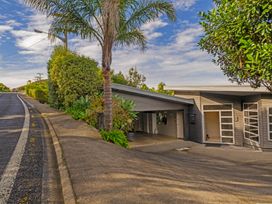 A house with a driveway and greenery at Bay View Escape - Whitianga Holiday Home in Whitianga