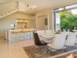 A dining room with a table and chairs at Bay View Escape - Whitianga Holiday Home Whitianga
