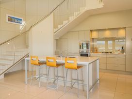 A kitchen with a stove and island at Bay View Escape - Whitianga
