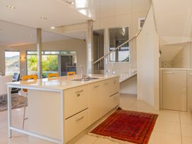 A kitchen with an island and sink at Bay View Escape - Whitianga