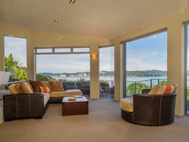 A living room with a sofa and coffee table at Bay View Escape - Whitianga Holiday Home in Whitianga